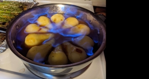 Flambeed Vanilla-Poached Pears with Apricot Sauce
